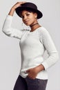 Young beautiful hipster black girl in white sweater and hat Royalty Free Stock Photo