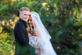 Portrait of young beautiful interracial newlyweds on green foliage background Royalty Free Stock Photo