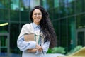 Portrait of young beautiful Latin American female student, woman with books and notebooks smiling and looking at camera Royalty Free Stock Photo