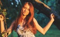 Portrait of young beautiful long-haired redhaired woman in apple orchard Royalty Free Stock Photo