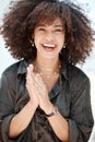 Portrait of a young beautiful mixed race woman with natural curly afro hair style smiling and laughing outside. Young Royalty Free Stock Photo