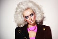 Portrait of young beautiful platinum blond woman with bold eyebrows and 80s style makeup Royalty Free Stock Photo