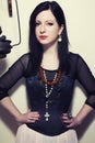 Portrait of a young beautiful Polish girl with green eyes dressed in a corset against the background of a vintage coffee grinder Royalty Free Stock Photo