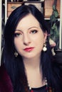 Portrait of a young beautiful Polish girl with green eyes dressed in a corset against the background of a vintage coffee grinder Royalty Free Stock Photo