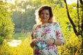 Portrait of young beautiful pregnant woman.She holds in her hands little baby booties