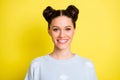 Portrait of young beautiful pretty charming smiling girl with top-knots wear light blue jumper isolated on yellow color