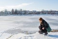 Portrait of a young beautiful red hair european girl sitting near river and looking down Royalty Free Stock Photo