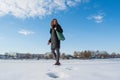 Portrait of a young beautiful red hair european girl walking on snowy frozen river and looking back Royalty Free Stock Photo