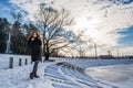 Portrait of a young beautiful red hair european girl in winter season near frozen river Royalty Free Stock Photo