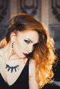 Portrait of young beautiful red-haired girl in the image of a Gothic witch on Halloween Royalty Free Stock Photo