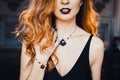 Portrait of young beautiful red-haired girl in the image of a Gothic witch on Halloween Royalty Free Stock Photo