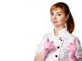 Portrait of young beautiful red-haired woman doctor or nurse in white special uniform and gloves holding syringe in hands Royalty Free Stock Photo