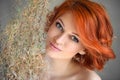 Portrait of young beautiful redhaired woman with dried flowers Royalty Free Stock Photo