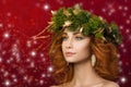 Portrait of young beautiful redhaired woman with firry wreath Royalty Free Stock Photo