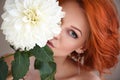 Portrait of young beautiful redhaired woman with white flower. Beauty portrait Royalty Free Stock Photo