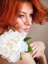 Portrait of young beautiful redhaired woman with white flower Royalty Free Stock Photo