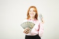 Attractive young businesswoman posing with bunch of USD cash in hands showing positive emotions and happy facial expression. Royalty Free Stock Photo