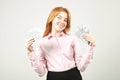 Attractive young businesswoman posing with bunch of USD cash in hands showing positive emotions and happy facial expression. Royalty Free Stock Photo