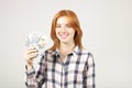 Attractive young businesswoman posing with bunch of USD cash in hands showing positive emotions and happy facial expression. Royalty Free Stock Photo