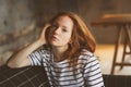 Portrait of young beautiful redhead woman relaxing at home in the autumn ot winter cozy evening