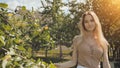 Portrait of a young beautiful seventeen-year-old blonde girl in the apple orchard. Royalty Free Stock Photo