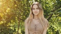 Portrait of a young beautiful seventeen-year-old blonde girl in the apple orchard. Royalty Free Stock Photo