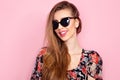 Portrait of young beautiful slim woman in sexy dress with sensual lips in studio wearing sunglasses. smiling and posing Royalty Free Stock Photo