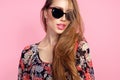 Portrait of young beautiful slim woman in sexy dress with sensual lips in studio wearing sunglasses. smiling and posing Royalty Free Stock Photo