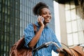 Portrait of young beautiful smiling african woman talking phone Royalty Free Stock Photo