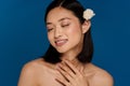Portrait of young beautiful smiling asian woman with flower Royalty Free Stock Photo
