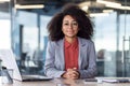 Portrait of young beautiful smiling businesswoman at workplace inside office, woman in business suit smiling and looking Royalty Free Stock Photo