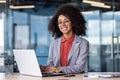 Portrait of young beautiful smiling businesswoman at workplace inside office, woman in business suit smiling and looking Royalty Free Stock Photo