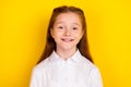 Portrait of young beautiful smiling positive schoolgirl go back to school first day isolated on yellow color background
