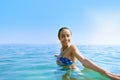 Portrait of young beautiful smiling woman with tanned body in the sea on tropical sunny beach. Summer vacation and Royalty Free Stock Photo