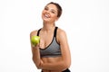 Portrait of young beautiful sportive girl holding apple over white background. Royalty Free Stock Photo