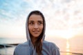 Portrait of young beautiful sportive girl at sunrise over seaside.