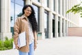 Portrait of young beautiful successful business woman outside office building, successful Latin American woman smiling Royalty Free Stock Photo