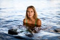 portrait of young beautiful tanned blue-eyed woman in water Royalty Free Stock Photo