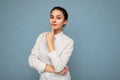 Portrait of young beautiful thoughtful brunette woman with sincere emotions wearing casual srtriped white