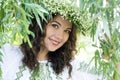 Portrait of a young beautiful in traditional Ukrainian embroidered shirt and a wreath of lilies of the valley Royalty Free Stock Photo