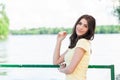 Portrait of young beautiful woman against lake in summer city park. Royalty Free Stock Photo