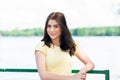 Portrait of young beautiful woman against lake in summer city park. Royalty Free Stock Photo