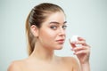 Portrait of young beautiful woman applying moisturizing cream on her face Royalty Free Stock Photo