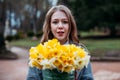 Portrait of a young beautiful woman on autumn background with bouquet of bright yellow flowers. concept of good mood Royalty Free Stock Photo