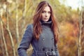 Portrait of young beautiful woman in autumn coat