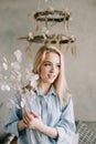 Portrait of a young beautiful woman in bed in the morning at home. Blonde girl in scandinavian interior. Good morning. Lifestyle. Royalty Free Stock Photo