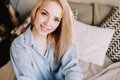 Portrait of a young beautiful woman in bed in the morning at home. Blonde girl in scandinavian interior. Good morning. Lifestyle. Royalty Free Stock Photo