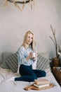 Portrait of a young beautiful woman in bed in the morning at home. Blonde girl in scandinavian interior. Good morning. Lifestyle. Royalty Free Stock Photo