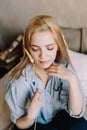 Portrait of a young beautiful woman in bed in the morning at home. Blonde girl in scandinavian interior. Good morning. Lifestyle. Royalty Free Stock Photo