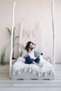 Portrait of a young beautiful woman in bed in the morning at home. Beautiful brunette in the bedroom. Good morning. Lifestyle. Royalty Free Stock Photo